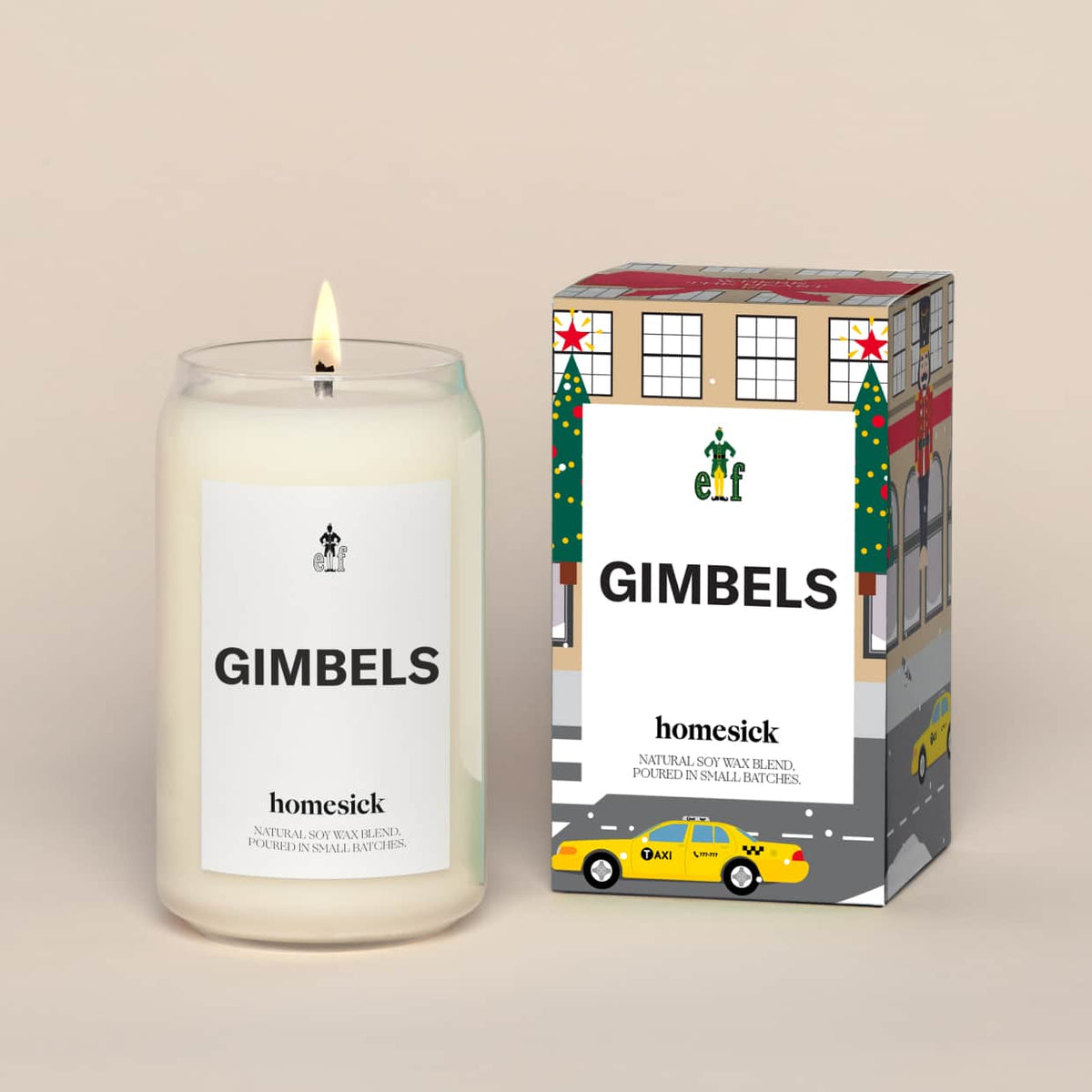 A lit Elf Gimbels Homesick candle displayed next to its boxed packaging on a dark cream background.
