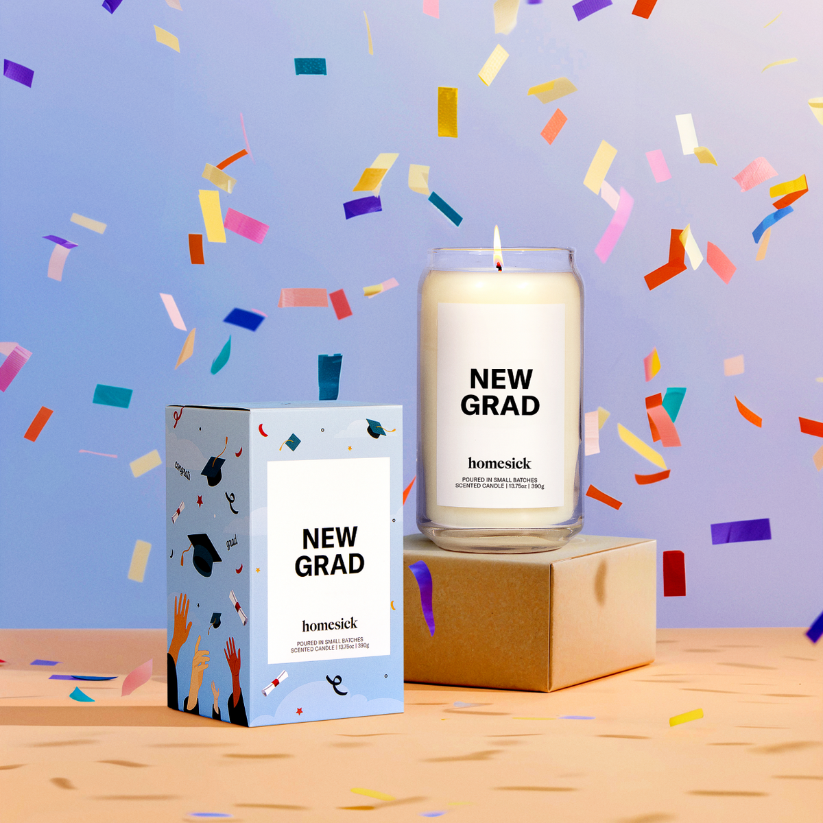 A lifestyle image of the New Grad Homesick candle surrounded by falling confetti.