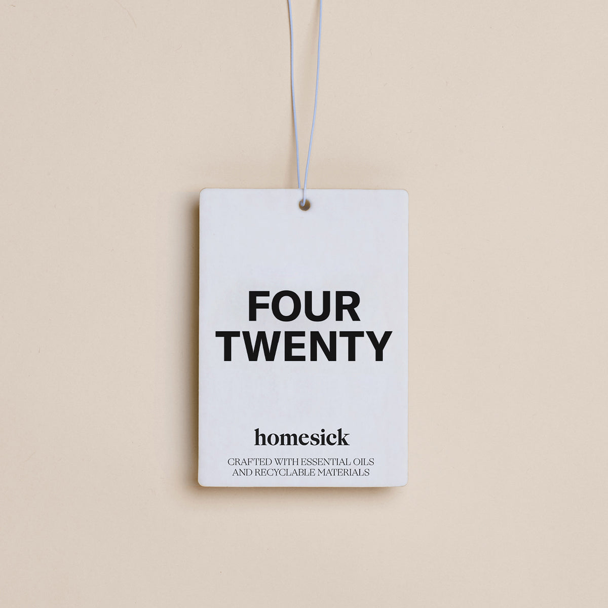 A Four Twenty Homesick Car Freshener displayed on a dark cream background.