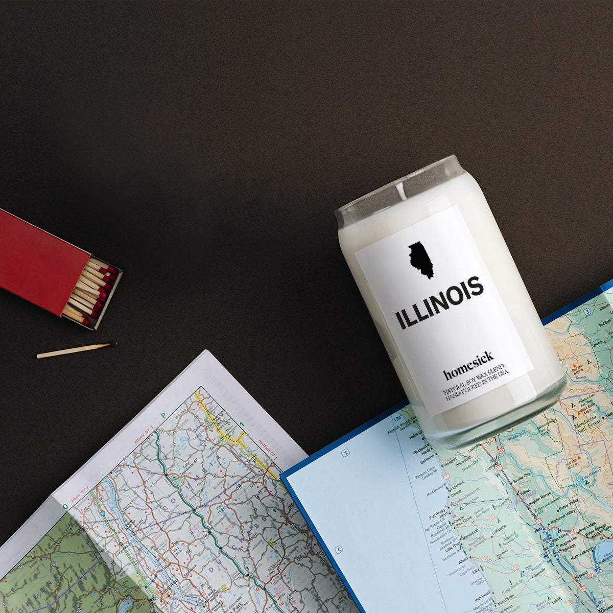 An over the headshot of the Illinois Candle on top of a handful of maps.
